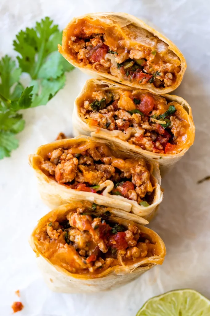 This healthier version of Meximelt is made with ground turkey seasoned with my own taco flavor and served inside a tortilla with pico de gallo and melted cheese.