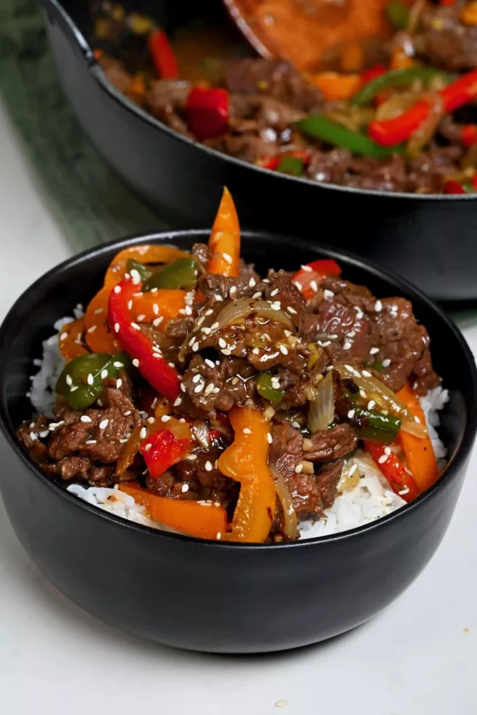 Thinly sliced flank steak is cooked in a flavorful sauce with red and green bell peppers in this pepper steak stir fry. A simple and quick dinner!

