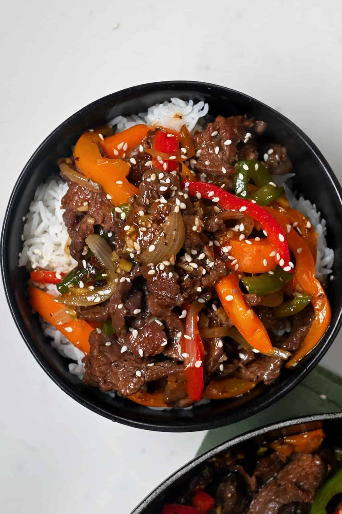 Thinly sliced flank steak is cooked in a flavorful sauce with red and green bell peppers in this pepper steak stir fry. A simple and quick dinner!

